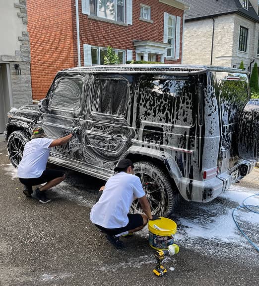 Panda Hub pros cleaning a car